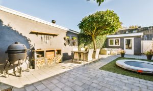 The courtyard of a house with well-groomed trees of a beautiful shape